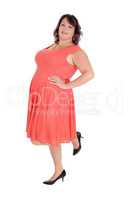 A plus size woman standing in a red dress