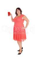 Plus-sized woman holding a red mug