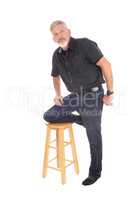 Middle aged man kneeling on chair