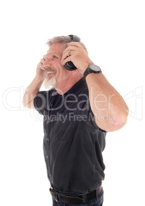 Middle age man having fun listening to music