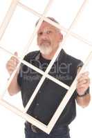 Middle age man holding window frame