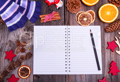 empty notebook in a line and a black pencil