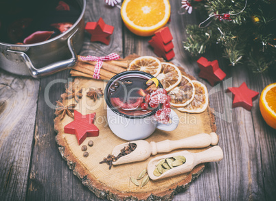 mulled wine in an iron mug and ingredients