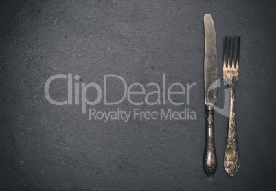 vintage iron fork and knife on a black background