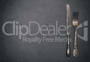 vintage iron fork and knife on a black background