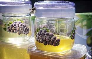 A variety of varieties of honey in jars offered for sale at the