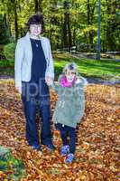 Woman with child in autumn park