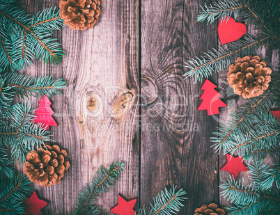 gray wood background with green spruce branches and Christmas de