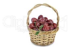 Cherries in a wicker basket isolated on a white background