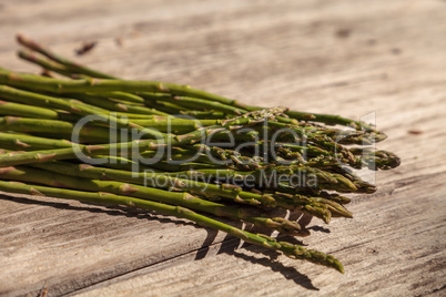 Fresh thin asparagus on the rustic wood background