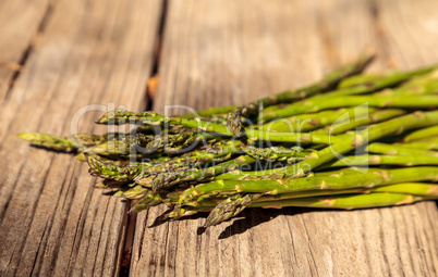 Fresh thin asparagus on the rustic wood background