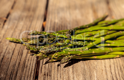 Fresh thin asparagus on the rustic wood background