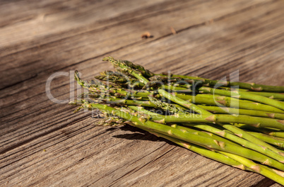 Fresh thin asparagus on the rustic wood background