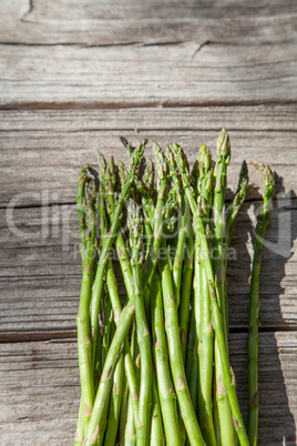 Fresh thin asparagus on the rustic wood background