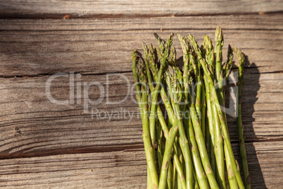 Fresh thin asparagus on the rustic wood background