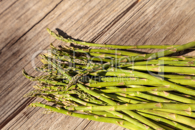 Fresh thin asparagus on the rustic wood background