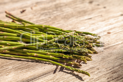 Fresh thin asparagus on the rustic wood background