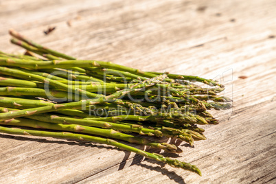 Fresh thin asparagus on the rustic wood background