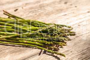 Fresh thin asparagus on the rustic wood background