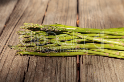 Fresh thin asparagus on the rustic wood background