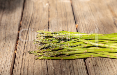 Fresh thin asparagus on the rustic wood background