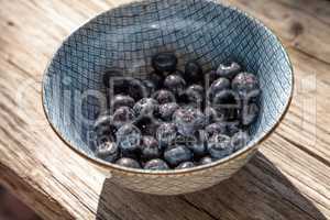 Organic blueberries in a blue and white bowl