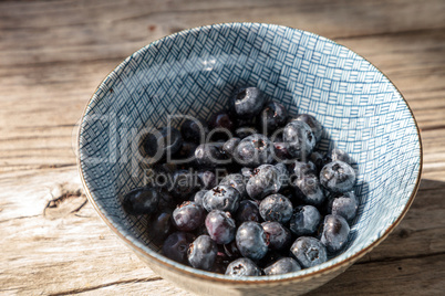 Organic blueberries in a blue and white bowl