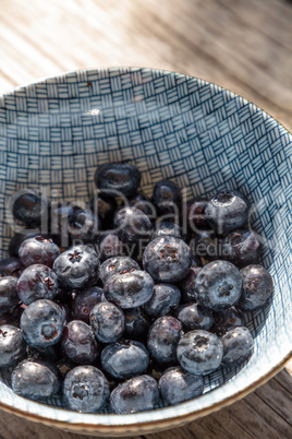 Organic blueberries in a blue and white bowl