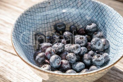 Organic blueberries in a blue and white bowl