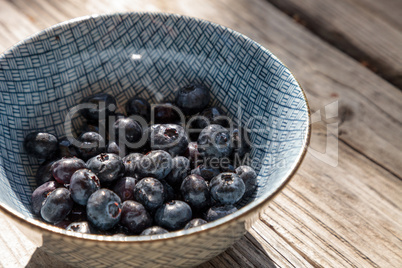 Organic blueberries in a blue and white bowl