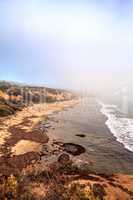 Fog drifts in over the ocean at Crystal Cove state beach