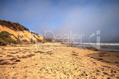 Fog drifts in over the ocean at Crystal Cove state beach