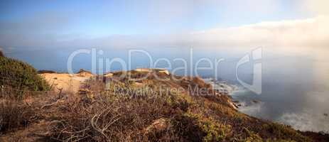 Fog drifts in over the ocean at Crystal Cove state beach