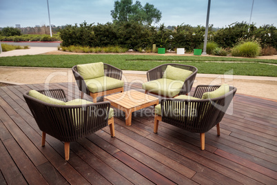 Wood patio lounge chairs with green cushions