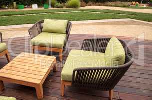 Wood patio lounge chairs with green cushions