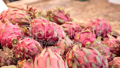 Red dragon fruit in a basket sold at a farmers market