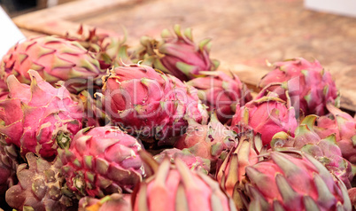 Red dragon fruit in a basket sold at a farmers market