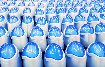 Deodorant, bottles with blue lids in a row.