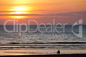 Fotograf im Sonnenuntergang am Strand