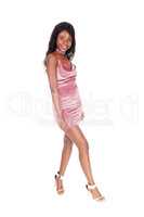 African woman in a pink dress posing