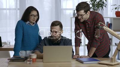 Business team works on project together at office