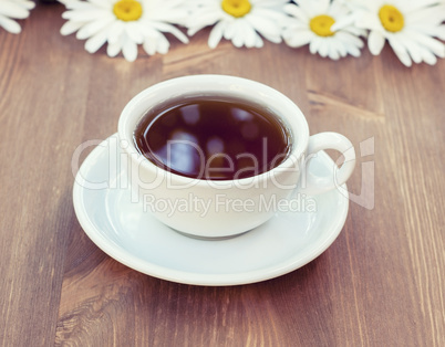 black tea in a white mug with a saucer