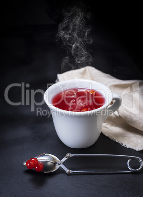 hot tea from a viburnum in a white ceramic mug