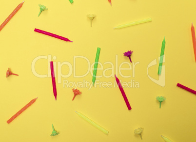 yellow background with wax candles for celebratory cake