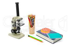 microscope, textbook and other school supplies isolated on white