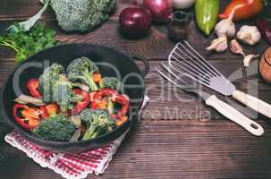 Fresh vegetables in a cast-iron black frying pan