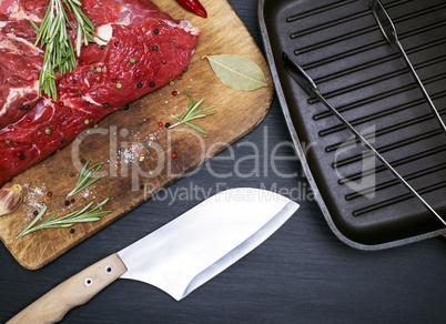 A fresh piece of beef on a kitchen cutting board