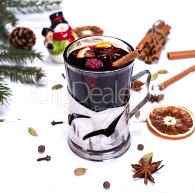 mulled wine in a glass on a white wooden background