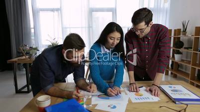 Business team analyzing income charts and graphs