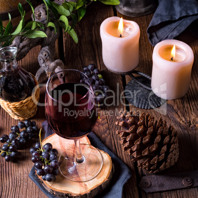 Red wine from a barrel with grapes and a glass of wine